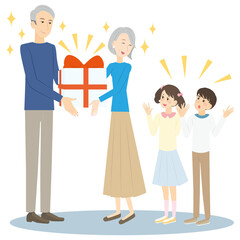 孫にプレゼントをするシニア夫婦