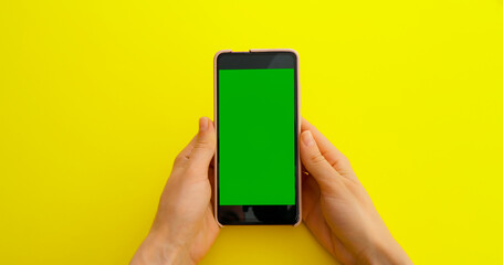 Woman watching content videos on Green Screen Chroma Key smartphone