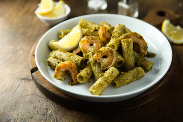 Pasta with pesto sauce and shrimps