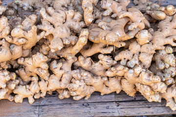 Fresh organic ginger roots pile at Thailand farmers market.