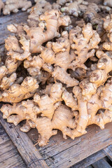 Fresh organic ginger roots pile at Thailand farmers market.