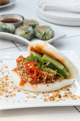 Taiwanese Food Gua Bao, Asian hamburger or sandwich from steamed rice bun with red-cooked pork...