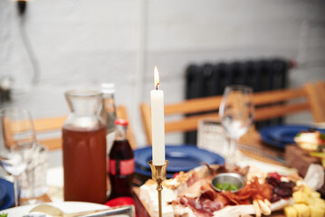 Festive table with delicious appetizers and snacks. Holiday banquet serving with fancy glasses and silverware in restaurant. Wedding birthday party celebration.