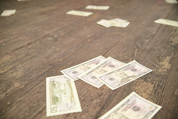 US Dollars scattered on a table as a theme party decoration. Mafia party celebration of a special...