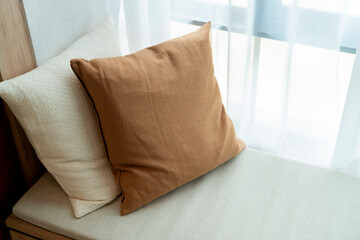 Close-up of beige earth tone pillow cushion set arrange on sofa couch in living room interior...