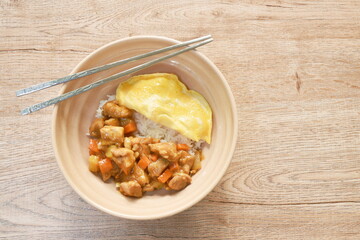 chicken curry with fried egg topping on rice in bowl 