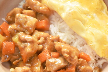 chicken curry with fried egg topping on rice in bowl 