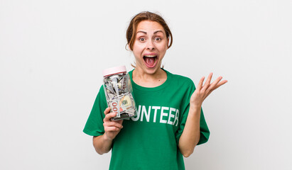 young pretty woman  feeling happy and astonished at something unbelievable. volunteer concept