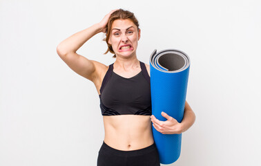 young pretty woman  feeling stressed, anxious or scared, with hands on head. fitness and yoga...