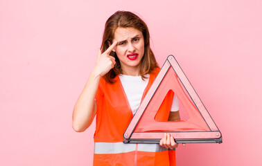 young pretty woman  feeling confused and puzzled, showing you are insane. car triangle emergency...
