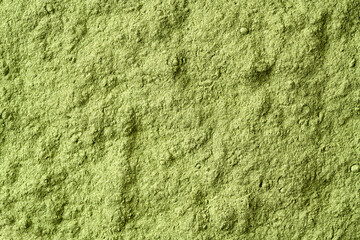 Surface made of green barley grass powder, top view