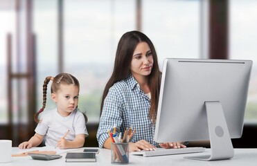 Happy busy mother working with a child on laptop