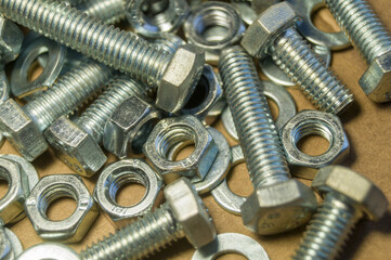 Various hardware. Metal fasteners. Bolts, nuts and washers. Soft focus, abstract, industrial background