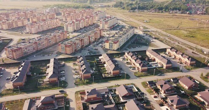 Aerial view of a luxurious village with smooth rows of two-storey duplex houses. Neighborhood in the area and real estate investments.