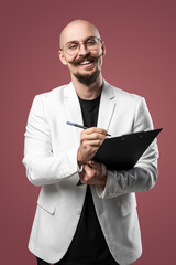 Balded man with mustache and beard in a business suit holding clipboard and pen isolated background.Concept of teacher, psychologist, student, lecturer