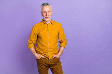 Photo of cool elder grey hairdo man wear yellow shirt isolated on purple color background