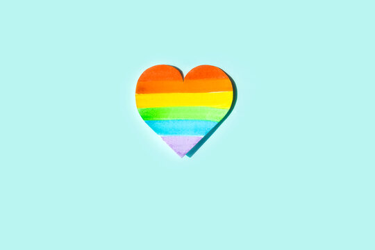 International Day Against Homophobia, Transphobia and Biphobia. May 17. Stop Homophobia. Heart with rainbow LGBT flag on a blue background.