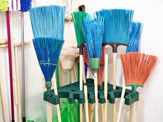 Colorful brooms for garden in store