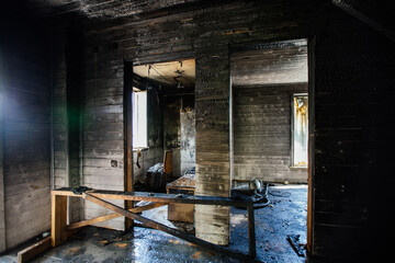 Burnt wooden house interior. Charred walls. Consequences of fire