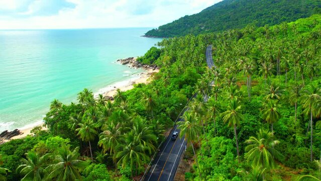 Drones are flying over beautiful beaches, roads and seas. The Gulf of Thailand. The turquoise waters are unique to the tropical seas. many coconut trees. Khanom-Sichon road. Nakhon Si Thammarat, Thail
