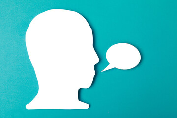  paper face and speech bubble on colorbackground copy space for text, communication, symbolic- Image