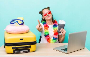 young pretty woman  smiling and looking friendly, showing number one. travel concept
