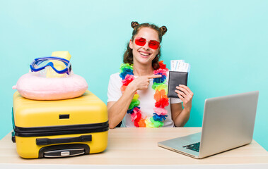 young pretty woman  smiling cheerfully, feeling happy and pointing to the side. travel concept