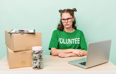 young pretty woman  feeling sad, upset or angry and looking to the side. donation volunteer concept