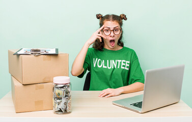 young pretty woman  looking surprised, realizing a new thought, idea or concept. donation volunteer...