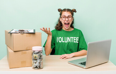 young pretty woman  feeling happy, surprised realizing a solution or idea. donation volunteer...
