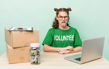 young pretty woman  feeling disgusted and irritated and tongue out. donation volunteer concept