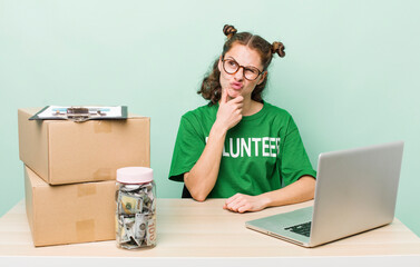 young pretty woman  thinking, feeling doubtful and confused. donation volunteer concept