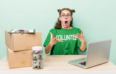 young pretty woman  feeling extremely shocked and surprised. donation volunteer concept