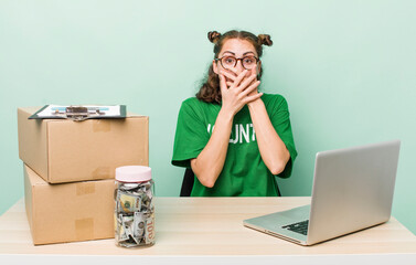 young pretty woman  covering mouth with hands with a shocked. donation volunteer concept