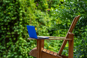 A laptop on a adirondack chair in a rainforest lodge, digital nomad concept, Chiriqui province,...