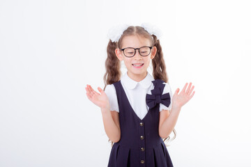 a little girl in glasses and a school uniform is isolated on a white background