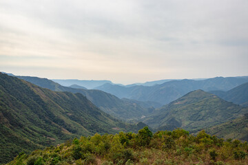 Fototapeta na wymiar mountain valley covered with forest and white mists at morning from flat angle