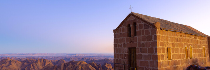 Church worship on greek orthodox chapel on Mount Sinai. Beautiful dawn in Egypt, early morning view of the top of Mountain.
