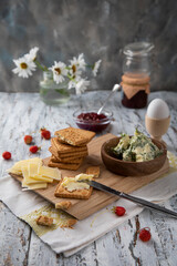 
Dill butter, biscuits and cheese on a rustic morning table