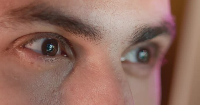 Close-up of a young man, eyes look at the monitor, work with a computer, laptop
