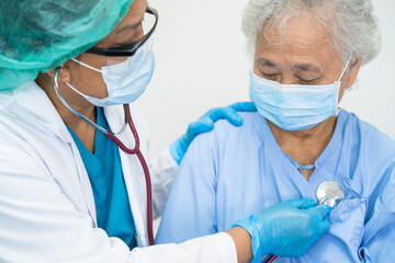 Doctor help Asian senior or elderly old lady woman patient wearing a face mask in hospital for...