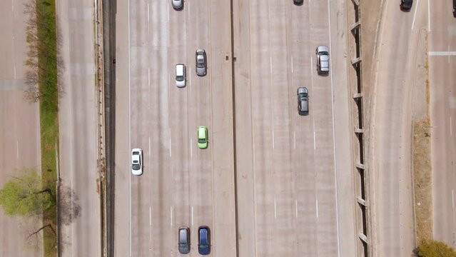 Aerial view above cars on the Texas State Highway Spur 366, in sunny Dallas, USA - birds eye, drone shot