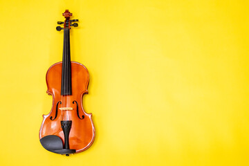 Classical music concert poster with orange color violin on yellow background with copy space for your text. online music courses. Invitation card with place for text
