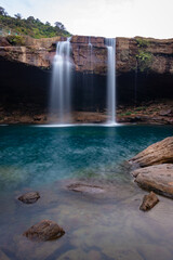 Naklejka premium waterfall streams falling from mountain top at morning long exposure shot from different angle