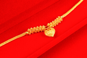 Gold Bracelet in red velvet box container.