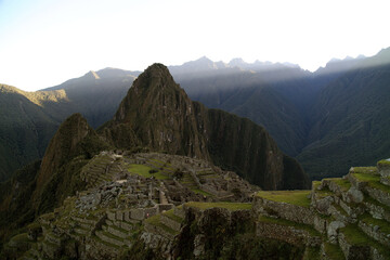 First rays of sunlight striking Machu Picchu at dawn, Peru
