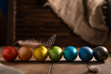 colorful rainbow Easter eggs on a wooden background