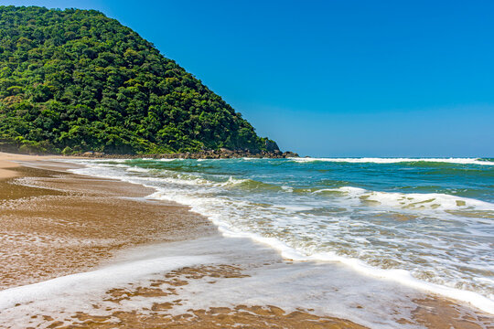 Beautiful deserted beach in Bertioga on the coast of S&Atilde;&pound;o Paulo state, Brazil with the hill and rainforest in the background