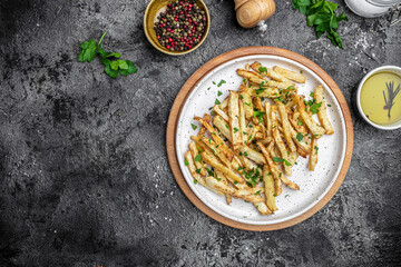 Roasted Parsnips on dark Background. side dish on plate. Delicious vegetarian breakfast or snack,...