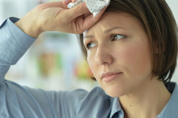 beautiful young ill woman with headache  at home